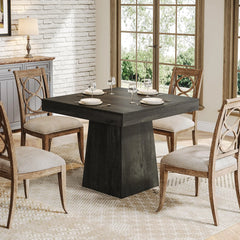 square dining table with wood finish and pedestal base
