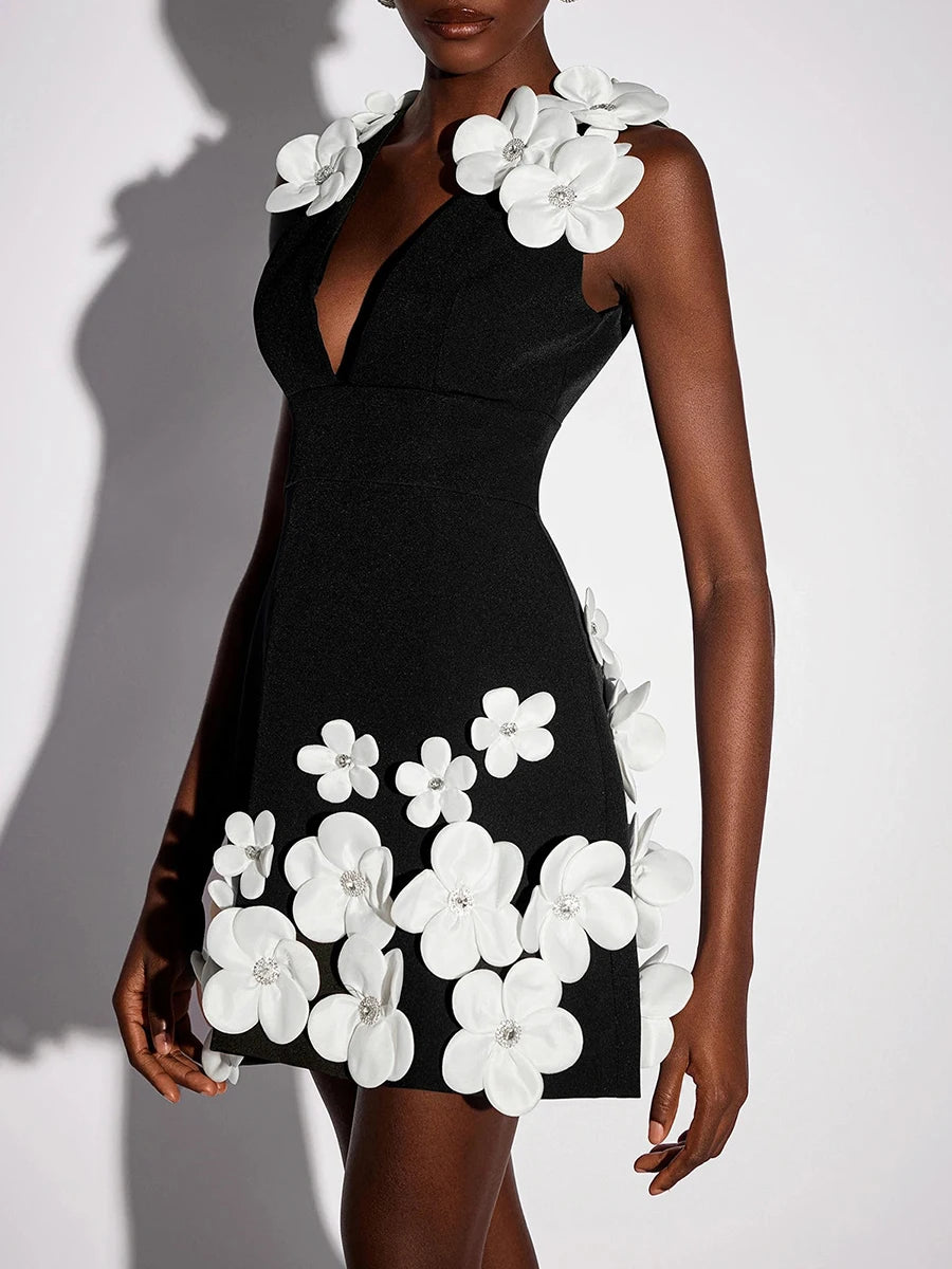 A woman modeling a 3D floral mini dress with delicate beading.
