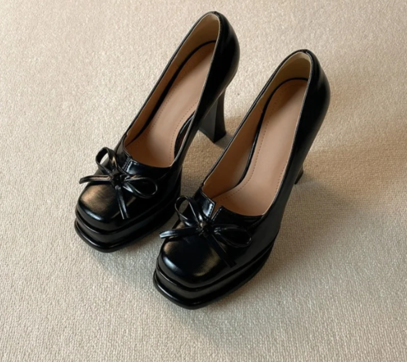 Black platform dress pumps with square toe and bow detail