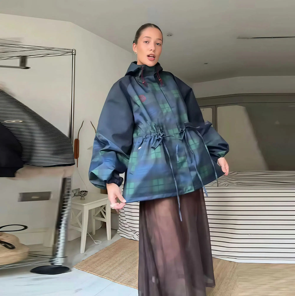 Person wearing a blue plaid jacket in an indoor setting