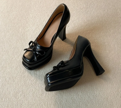 Side view of a black platform dress pump with chunky heel