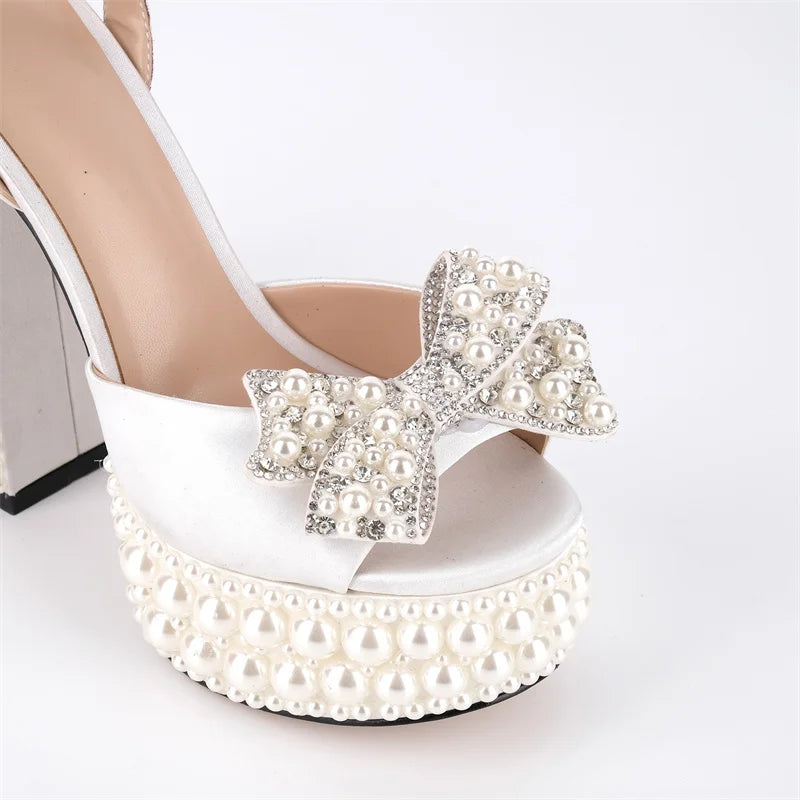 Close-up of pearl and crystal bow embellishment on sandals