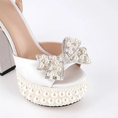 Close-up of pearl and crystal bow embellishment on sandals