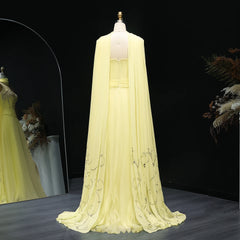Light yellow evening gown on a mannequin against a dark background