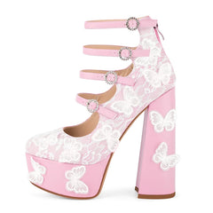 Pink high-heeled shoes with white lace and butterfly designs on a white background