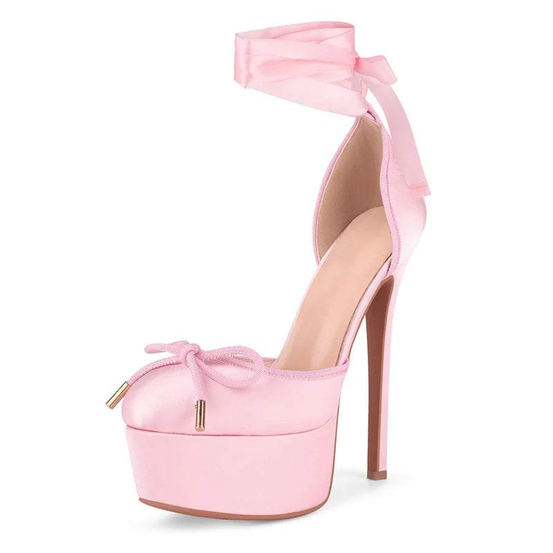 Pink high-heeled shoe with bow detail on a white background
