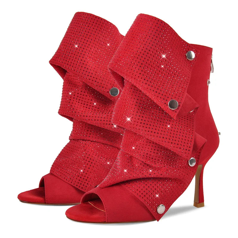 Pair of red stiletto ruched rhinestone peep toe ankle boots, front view.