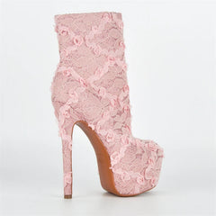 Pink lace high-heeled boot on a white background