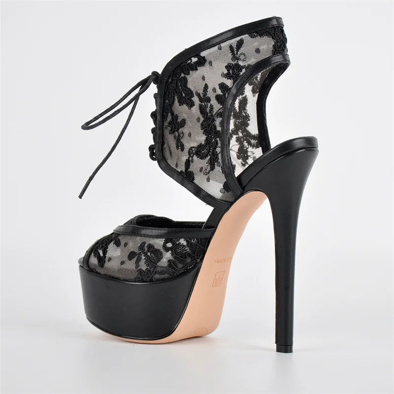 Black lace high-heeled shoe on a white background
