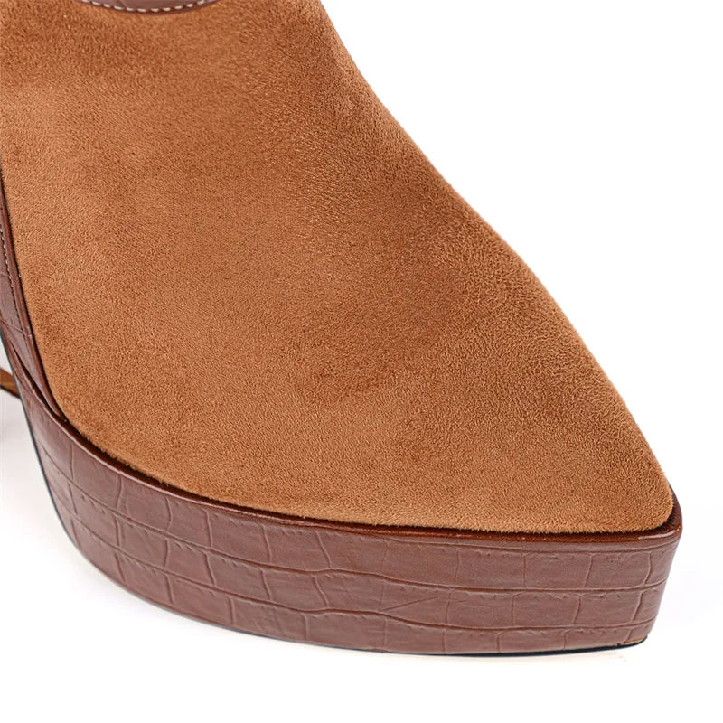 Close-up of the pointed toe and platform of fringed ankle boots