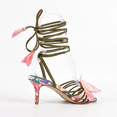 Close-up of floral print and flower accent on stiletto heels