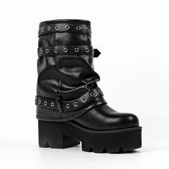 Side view of black faux leather platform ankle boots with buckle straps.