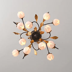 Antique black chandelier with 12 lights and pink tulip-shaped lamp shades, hanging from a ceiling. Golden Atelier 3