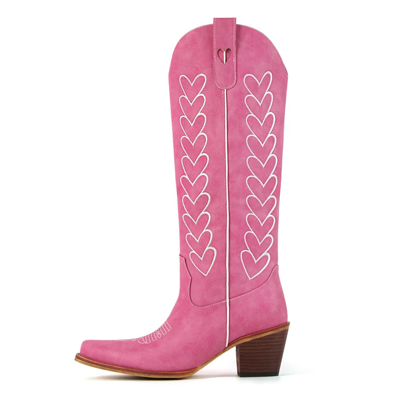Pink cowboy boot with heart patterns on a white background