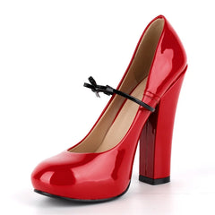 Red patent leather Mary Jane chunky heel pumps with a black bow detail.