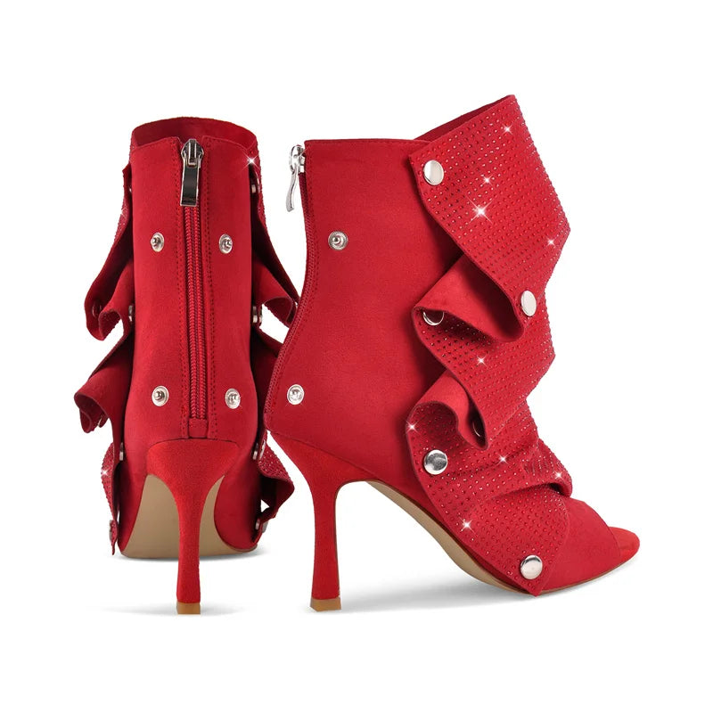 Pair of red stiletto ruched rhinestone peep toe ankle boots, back view.