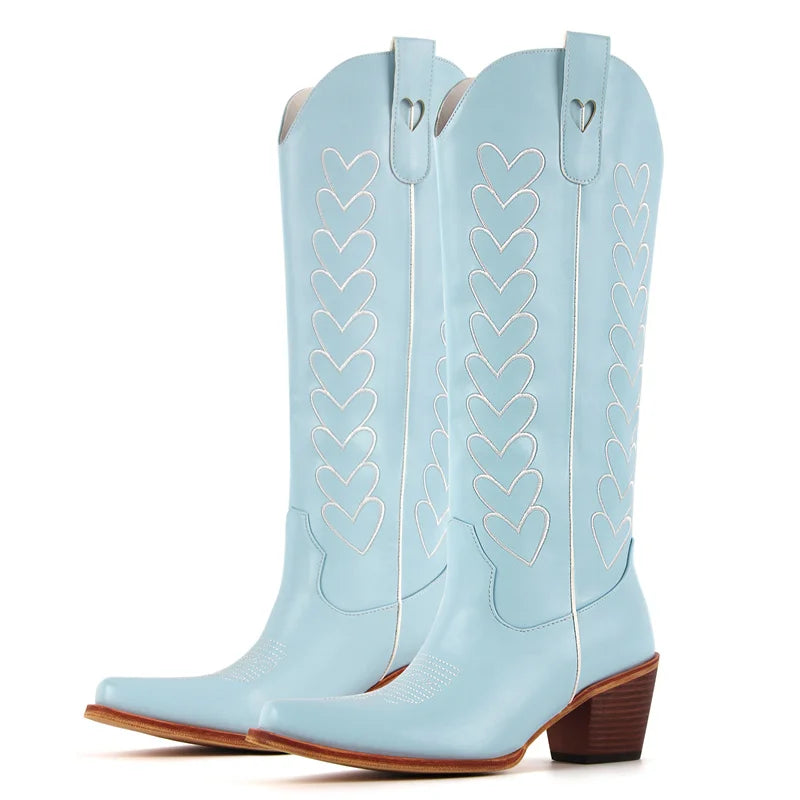 Light blue cowboy boots with heart patterns on a white background