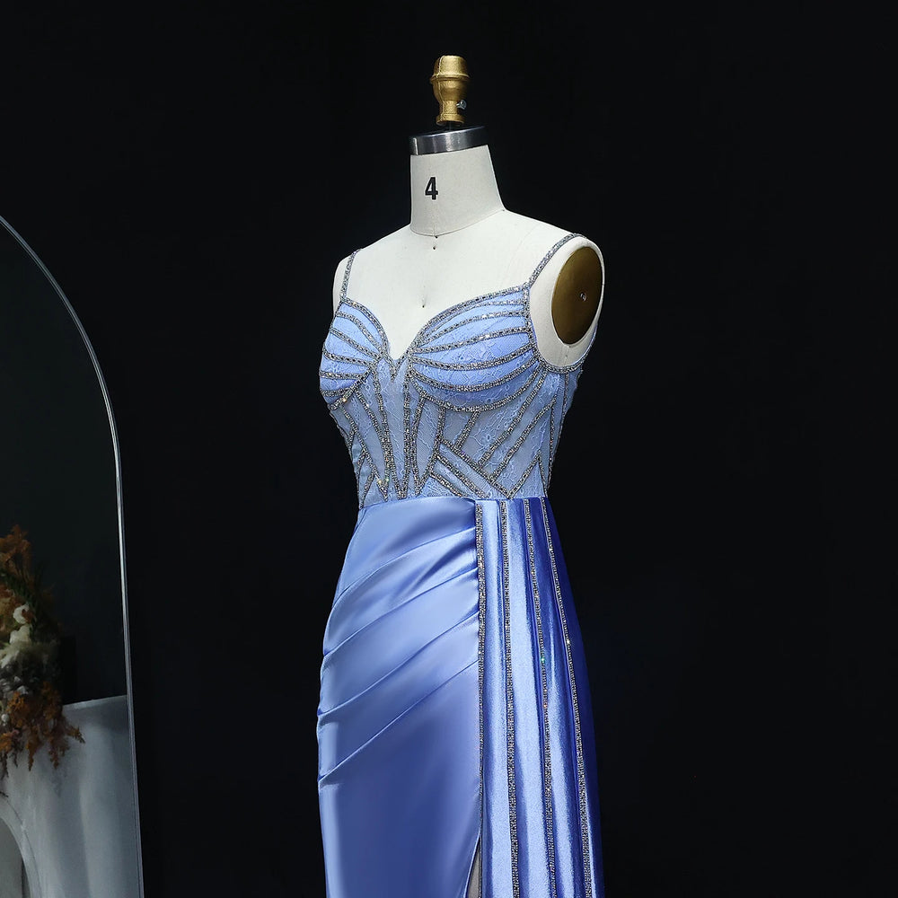 Mannequin wearing a light blue evening gown with beaded details on a black background