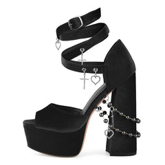 Black high-heeled platform shoe with decorative elements on a white background