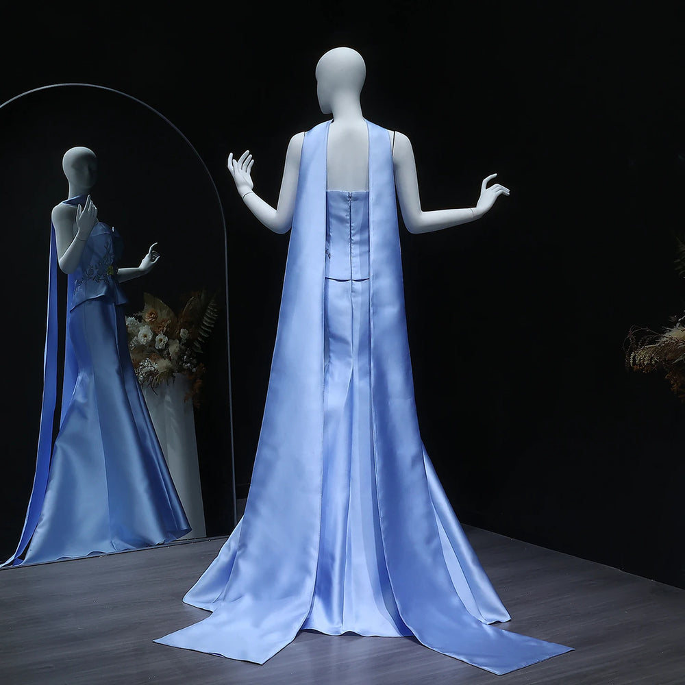 Mannequin wearing a light blue satin gown with a dark background