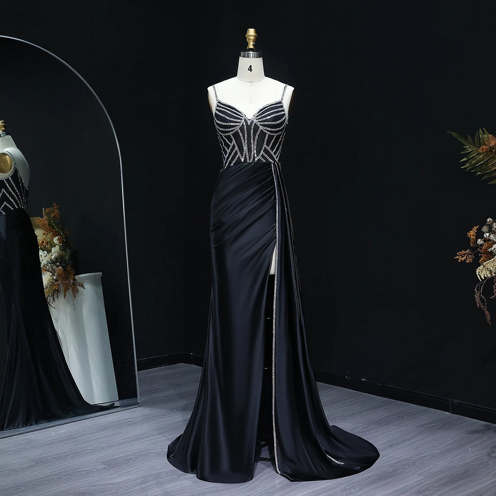Black evening gown on a mannequin against a dark background