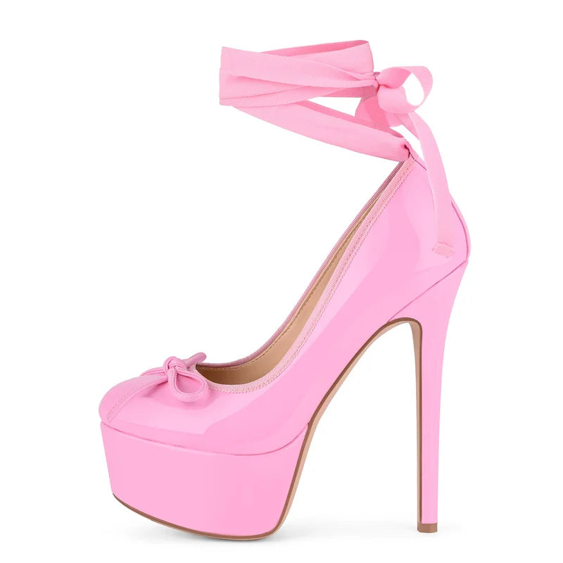 Pink high-heeled shoe with bow detail on a white background