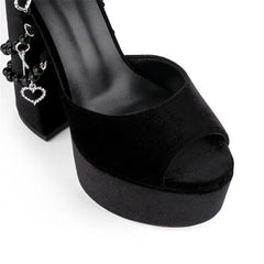 Black open-toe high-heeled shoe with platform on a white background