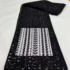 Black sequin fabric with a white pattern on a white background