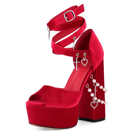 Red high-heeled shoe with heart and pearl decorations on a white background
