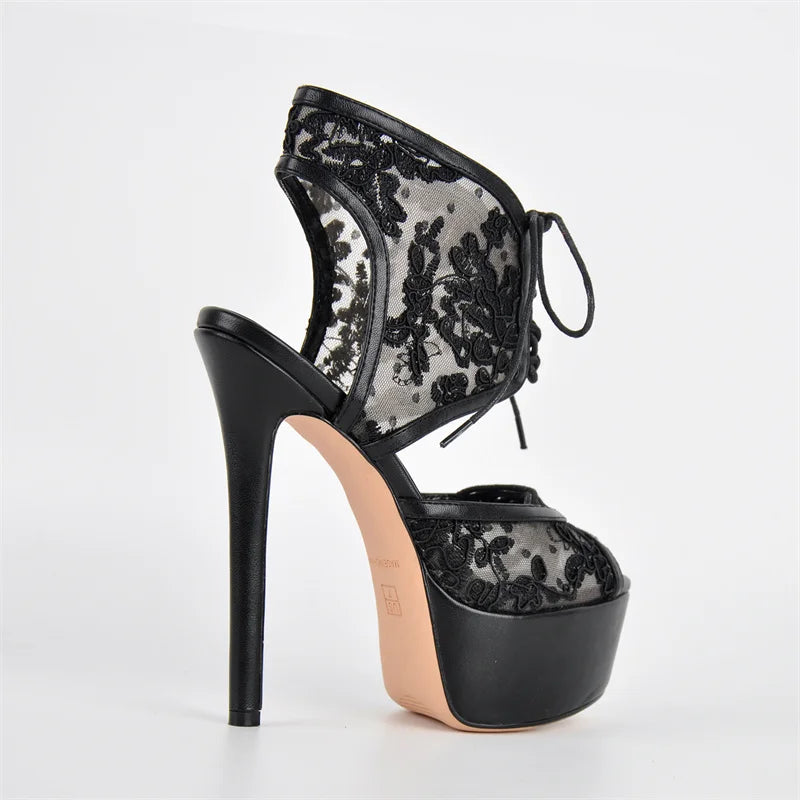 Black lace high-heeled shoe on a white background