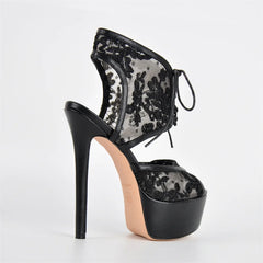 Black lace high-heeled shoe on a white background