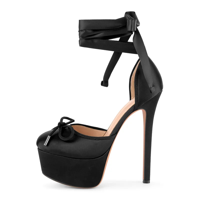 Black high-heeled sandal with bow detail on a white background
