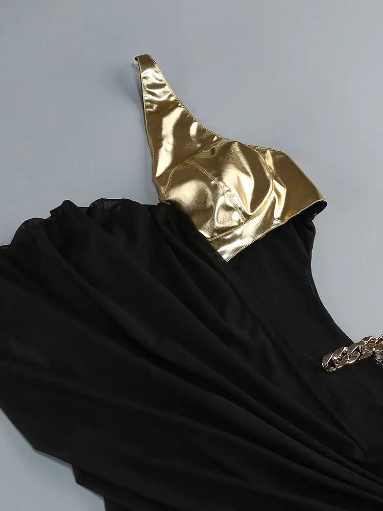Black dress with gold top on a gray background