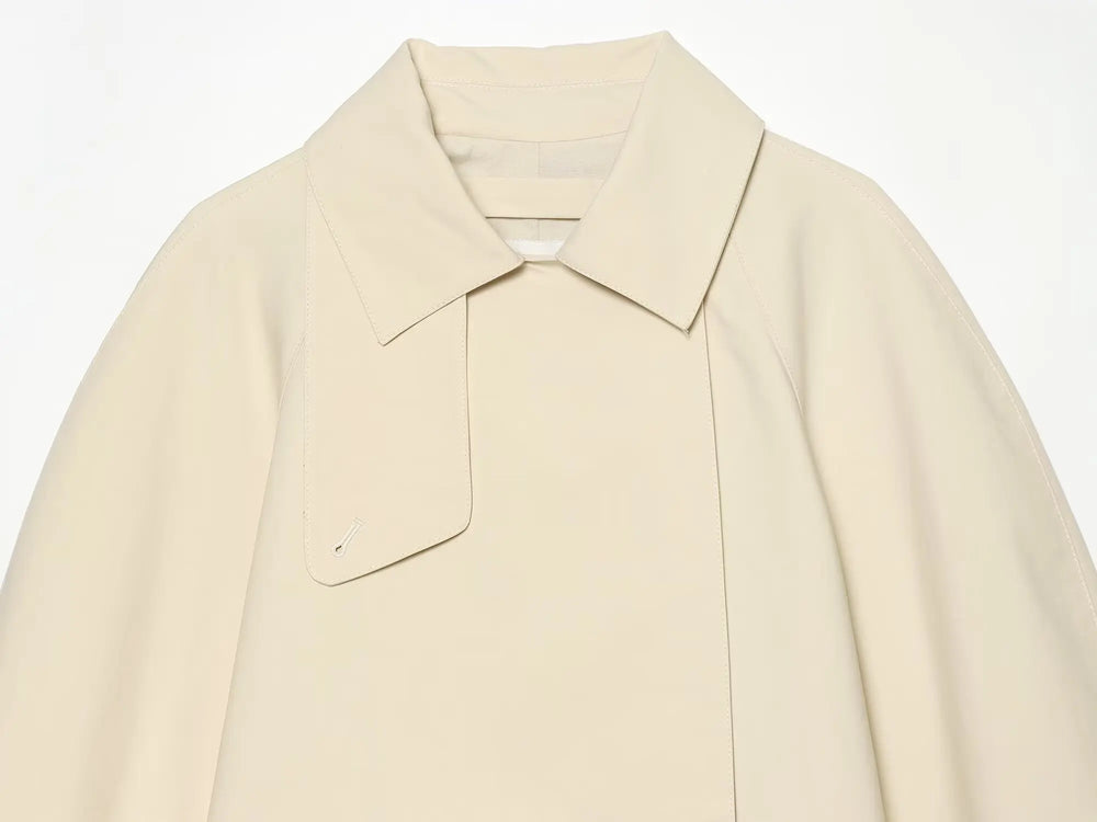 Model wearing asymmetric lapel single button jacket