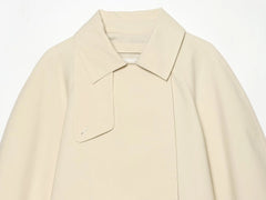 Model wearing asymmetric lapel single button jacket