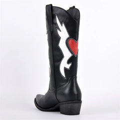 Close-up of embroidered heart detail on western boots