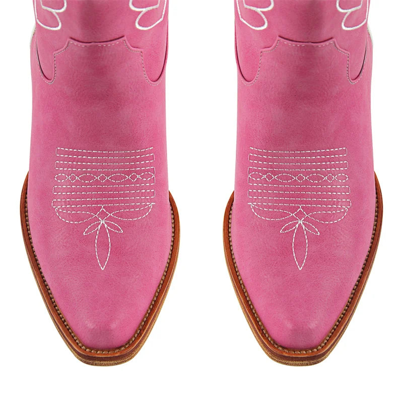 Top-down view of pink western boots with pointed toe and embroidery