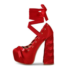 Red high-heeled shoe with platform sole on a white background