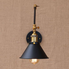  An adjustable swing arm wall-mounted LED light fixture with a black shade and brass accents.