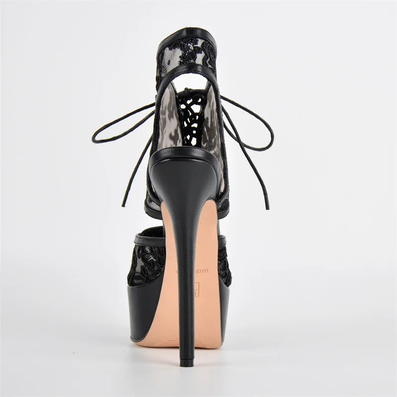 Black high-heeled shoe with floral lace-up design on a white background