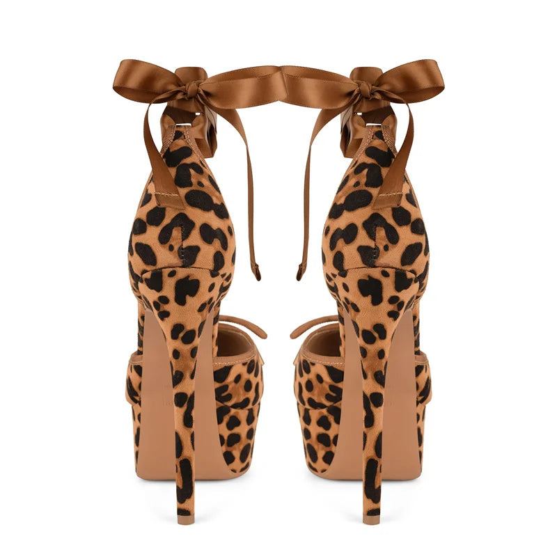 Leopard print high-heeled shoes with brown ribbons on a white background