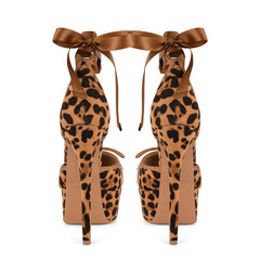 Leopard print high-heeled shoes with brown ribbons on a white background