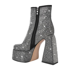 Side view of black rhinestone chunky platform ankle boots with zipper