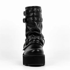 Front view of black faux leather platform ankle boots with multiple buckles.