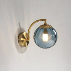 A modern  blue LED colour glass pendant light fixture mounted on a wall.