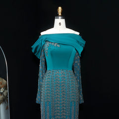 Teal  crystal sequined party dress in black for upscale cocktail occasions on a mannequin against a black background