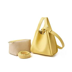 A faux leather bucket crossbody bag in yellow colour with an adjustable strap and drawstring closure.,  a layed down  beige  colored bag; 
