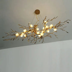 Branch-like chandelier with lights on a plain background