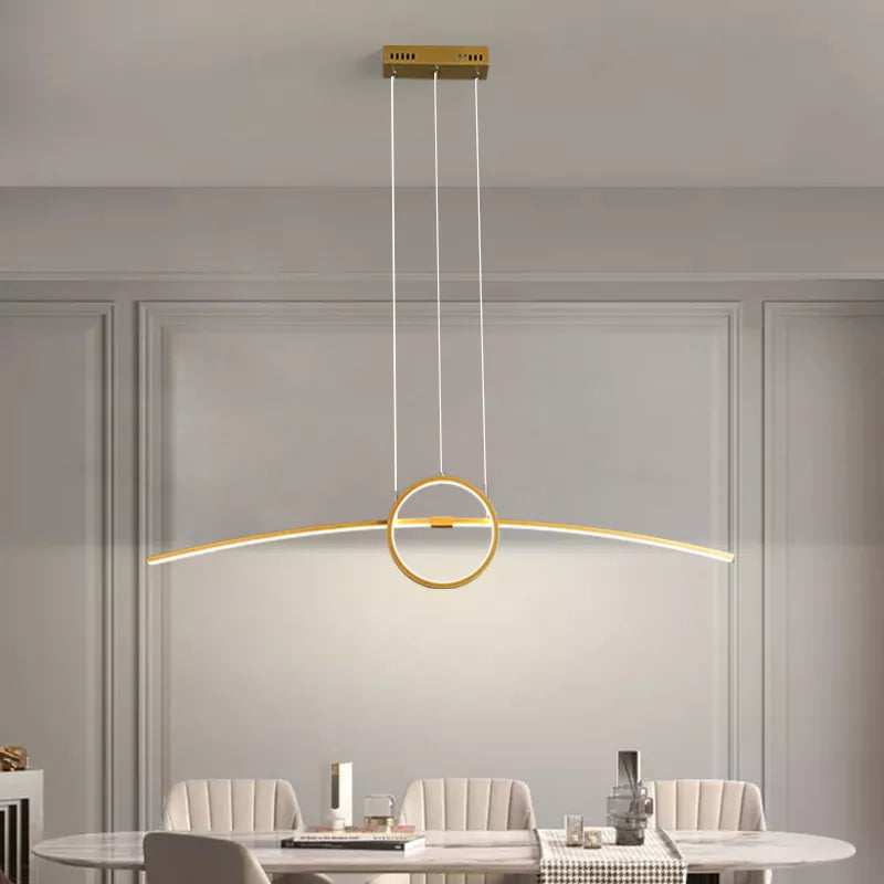 Golden Atelier LED pendant lamp with a modern design, hanging from a ceiling and casting a warm glow. Text overlay indicates voice control compatibility with Alexa. 1