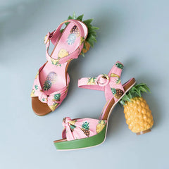 Close-up of the pineapple buckle detail and platform sole on the sandals. Golden Atelier 3